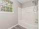 Clean bathroom with a modern shower-tub combination and a bright window at 5229 Kirk Dr, Atlanta, GA 30349