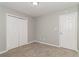 Bedroom with neutral carpet and walls, a double door closet and a door at 5229 Kirk Dr, Atlanta, GA 30349