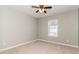 Empty room with grey walls, window, ceiling fan, and neutral carpet at 5229 Kirk Dr, Atlanta, GA 30349