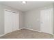 Bedroom with neutral carpet, ceiling light, closet, and door at 5229 Kirk Dr, Atlanta, GA 30349