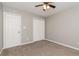 Bedroom with neutral carpet and walls, a window, a ceiling fan and a closet with double doors at 5229 Kirk Dr, Atlanta, GA 30349