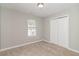 Bedroom with neutral carpet and walls, a window with blinds and a double door closet at 5229 Kirk Dr, Atlanta, GA 30349