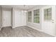 Dining area with modern flooring, closet, bright windows, and a door leading to the outside at 5229 Kirk Dr, Atlanta, GA 30349