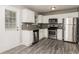 Modern kitchen featuring stainless steel appliances, white cabinets, and sleek countertops at 5229 Kirk Dr, Atlanta, GA 30349