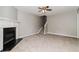 Bright living room features a classic fireplace, stairway, neutral walls, and carpet flooring at 5229 Kirk Dr, Atlanta, GA 30349
