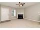 Cozy living room with fireplace, neutral walls, carpet flooring, and ceiling fan at 5229 Kirk Dr, Atlanta, GA 30349