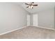 Large bedroom with neutral carpet, ceiling fan, spacious closet, and vaulted ceilings at 5229 Kirk Dr, Atlanta, GA 30349