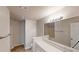 Bathroom featuring a double vanity, large mirror, and a shower-tub combo at 6614 Biscayne Blvd, Rex, GA 30273