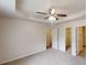 Neutral bedroom features a ceiling fan, plush carpet, and easy access to closet space at 6614 Biscayne Blvd, Rex, GA 30273