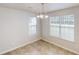 Bright dining area with a decorative chandelier and natural light from the windows at 6614 Biscayne Blvd, Rex, GA 30273