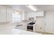 Efficient kitchen featuring white cabinets, stainless steel appliances, and plenty of counter space at 6614 Biscayne Blvd, Rex, GA 30273