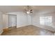 Spacious living room with vaulted ceiling, ceiling fan, and lots of natural light at 6614 Biscayne Blvd, Rex, GA 30273