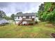 Exterior back view featuring a deck, yard and white siding at 70 Ashbury Ct, Dallas, GA 30157