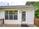 View of the house from the deck, showcasing a white exterior and wooded backyard at 70 Ashbury Ct, Dallas, GA 30157