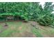 Backyard with mature trees, a fire pit, and a swing at 70 Ashbury Ct, Dallas, GA 30157