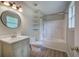 Bathroom features a shower-tub combo, modern vanity, updated fixtures and round mirror at 70 Ashbury Ct, Dallas, GA 30157