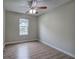 Bedroom featuring a ceiling fan, window and light wood flooring at 70 Ashbury Ct, Dallas, GA 30157