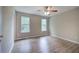 Bright bedroom featuring wood flooring and two windows at 70 Ashbury Ct, Dallas, GA 30157