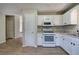 Kitchen with white cabinets and stainless-steel appliances with wood flooring at 70 Ashbury Ct, Dallas, GA 30157