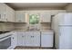 Bright kitchen features white cabinets, wood flooring, and stainless-steel appliances at 70 Ashbury Ct, Dallas, GA 30157