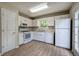 Bright kitchen features white cabinets, wood flooring, and stainless-steel appliances at 70 Ashbury Ct, Dallas, GA 30157
