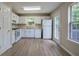Bright kitchen features white cabinets, wood flooring, and stainless-steel appliances at 70 Ashbury Ct, Dallas, GA 30157