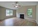 Living room with vaulted ceiling, fireplace, fan and wood-look floors at 70 Ashbury Ct, Dallas, GA 30157