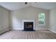 Bright living room with fireplace, vaulted ceiling, and wood-look floors at 70 Ashbury Ct, Dallas, GA 30157