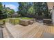Spacious wooden deck with an outdoor dining table, seating, and grill, great for entertaining at 1175 Haven Brook Ne Way, Brookhaven, GA 30319