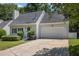 Inviting front exterior showcasing a well-maintained home with a two-car garage and landscaped yard at 1175 Haven Brook Ne Way, Brookhaven, GA 30319