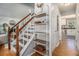 Hallway with wood floors, stairs, and decorative shelving, leading to the kitchen and living areas at 1175 Haven Brook Ne Way, Brookhaven, GA 30319