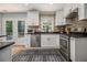 Modern kitchen features stainless steel appliances, white cabinets, and a view of the outdoor deck at 1175 Haven Brook Ne Way, Brookhaven, GA 30319