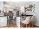 Bright kitchen with white cabinetry, stainless steel appliances, and a cozy breakfast bar area at 1175 Haven Brook Ne Way, Brookhaven, GA 30319