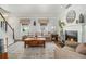 Bright living room features hardwood floors, a fireplace, and a comfortable seating area at 1175 Haven Brook Ne Way, Brookhaven, GA 30319