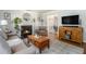 Cozy living room with a fireplace, hardwood floors, and a view into the dining area at 1175 Haven Brook Ne Way, Brookhaven, GA 30319