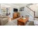 Inviting living room boasts hardwood floors, a decorative rug, and a staircase leading to the upper level at 1175 Haven Brook Ne Way, Brookhaven, GA 30319