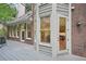 Back porch showcases brick walls and large windows offering peaceful views of the surrounding landscape at 1243 Williamswood Pointe, Decatur, GA 30033