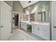 Modern bathroom with double vanities, stylish lighting, and white tile flooring at 1243 Williamswood Pointe, Decatur, GA 30033