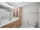 Bathroom with wood vanity, white sink, and decorative mirror at 1243 Williamswood Pointe, Decatur, GA 30033