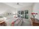 Calm bedroom featuring three windows, neutral walls, and plush carpet at 1243 Williamswood Pointe, Decatur, GA 30033