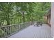 Wide deck surrounded by lush trees and greenery, with a table and chairs for outdoor enjoyment at 1243 Williamswood Pointe, Decatur, GA 30033