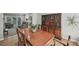 Elegant dining room with a large wooden table, chairs, hardwood floors, and a decorative china cabinet at 1243 Williamswood Pointe, Decatur, GA 30033