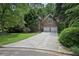 Brick home with attached garage, driveway, and well-maintained lawn with mature trees at 1243 Williamswood Pointe, Decatur, GA 30033