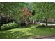 Manicured front lawn, mature shade trees in a well-landscaped front yard at 1243 Williamswood Pointe, Decatur, GA 30033