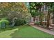 Charming brick home with a lush front yard, walkway, and inviting rocking chairs at 1243 Williamswood Pointe, Decatur, GA 30033