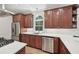 The kitchen boasts stainless steel appliances, white countertops, and elegant wooden cabinets at 1243 Williamswood Pointe, Decatur, GA 30033