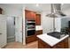Well-equipped kitchen with an island cooktop, built-in oven, and ample cabinet space with white countertops at 1243 Williamswood Pointe, Decatur, GA 30033