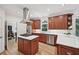 Modern kitchen with stainless steel appliances, a center island, custom cabinets, and bright countertops at 1243 Williamswood Pointe, Decatur, GA 30033