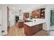 Beautiful kitchen with stainless appliances, a cooktop island, and access to an outdoor deck area, and hardwood floors at 1243 Williamswood Pointe, Decatur, GA 30033