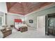 Luxurious main bedroom with wood ceiling, seating area, and an open doorway at 1243 Williamswood Pointe, Decatur, GA 30033